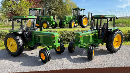 Group of UK-spec John Deere 4040 2WD Mk2 tractors outdoors in a field, green with yellow rims