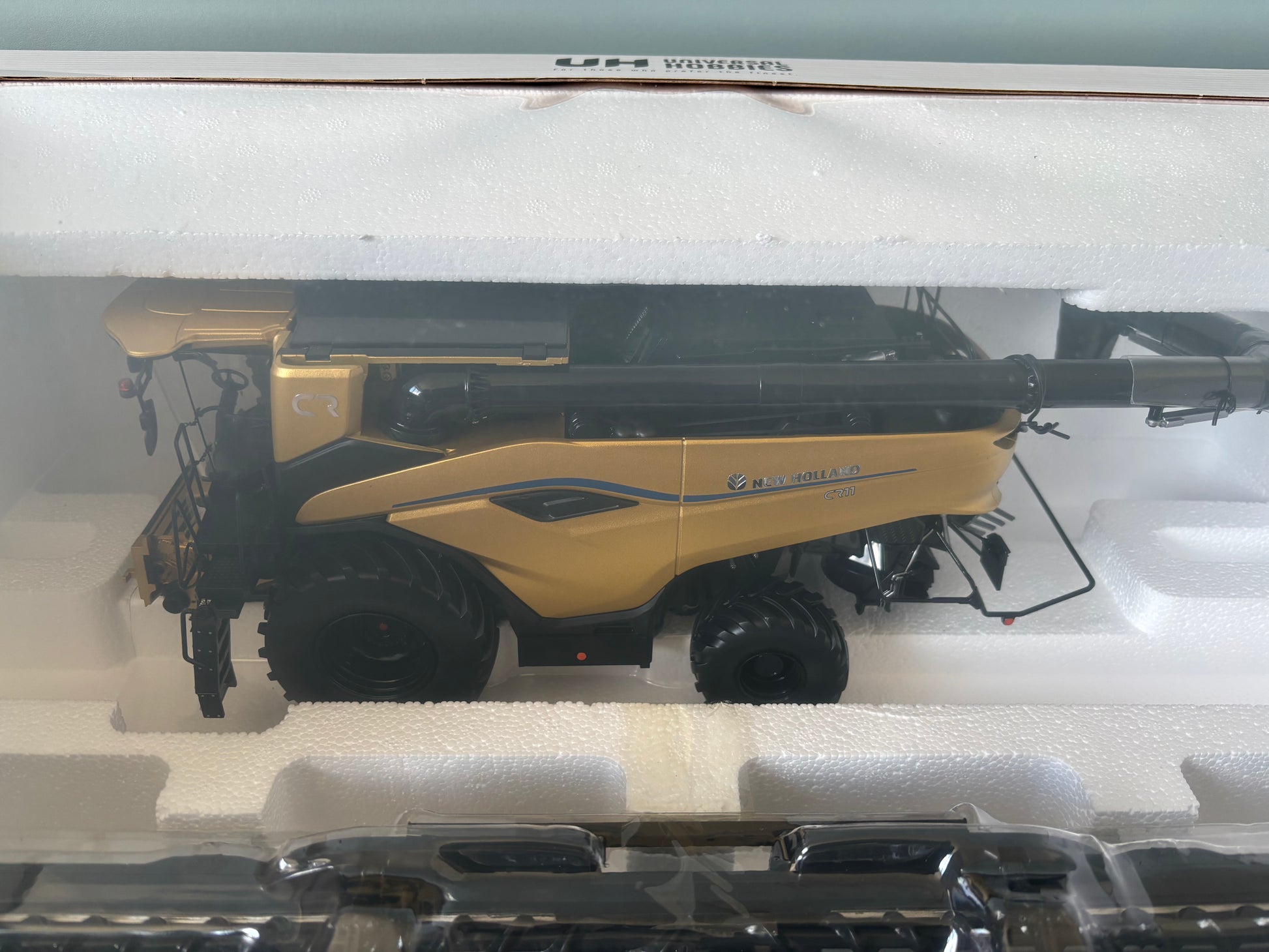1:32 scale New Holland CR11 Gold Limited Edition combine harvester UH6829 by Universal Hobbies, gold display model.